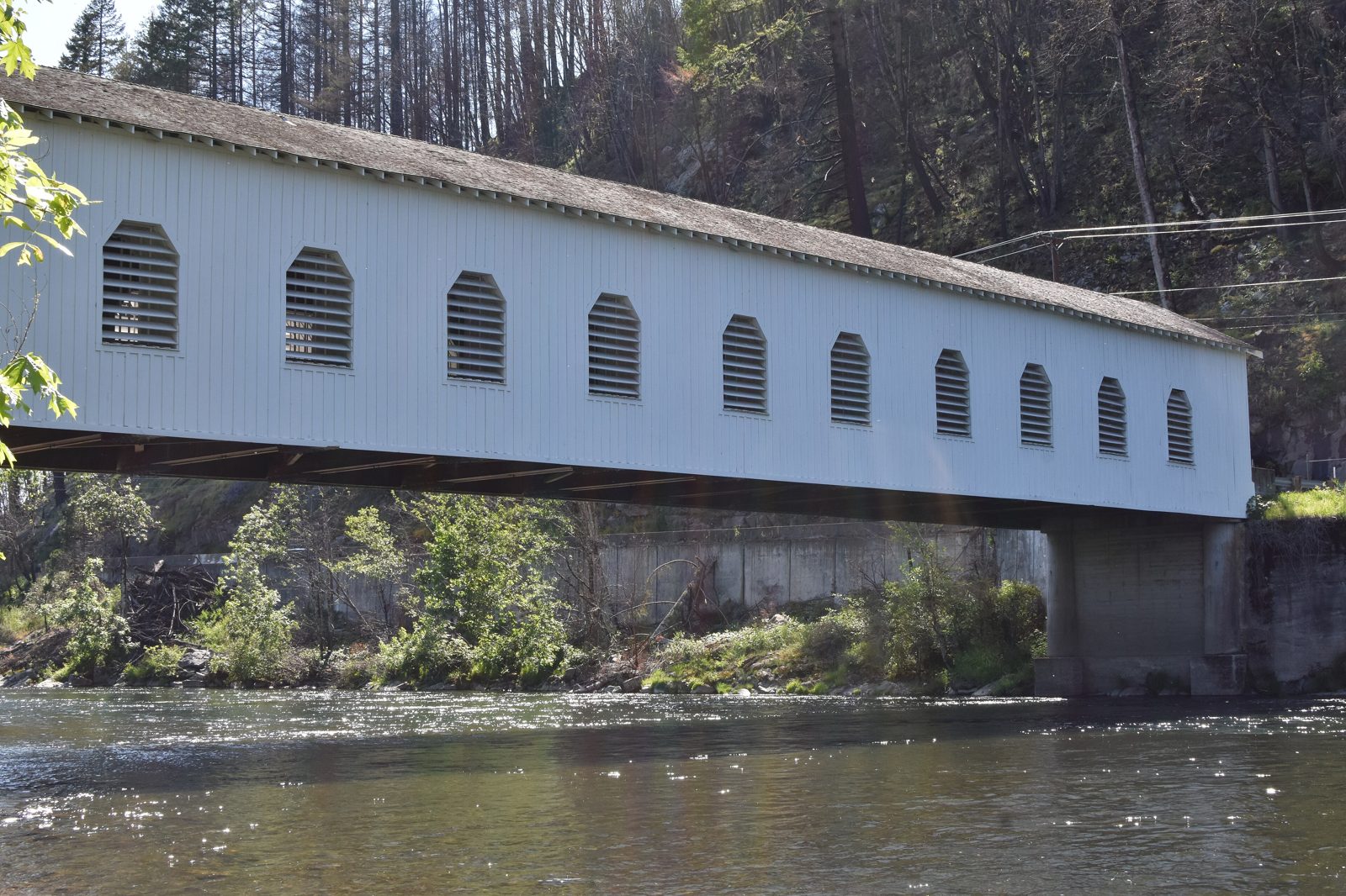 The white Goodpasture covered bridge spanning the McKenzie River at Vida